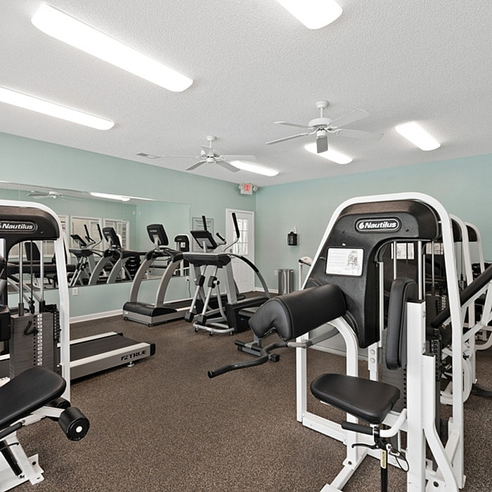 Modern fitness center with state-of-the-art exercise equipment and sleek interior design.