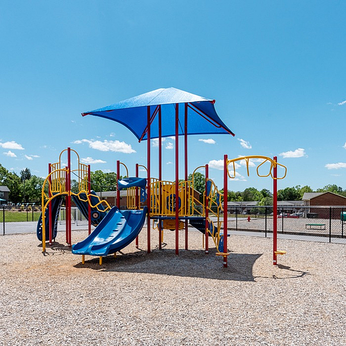 Vibrant playground with colorful slides and climbing structures, perfect for children to enjoy sunny days.