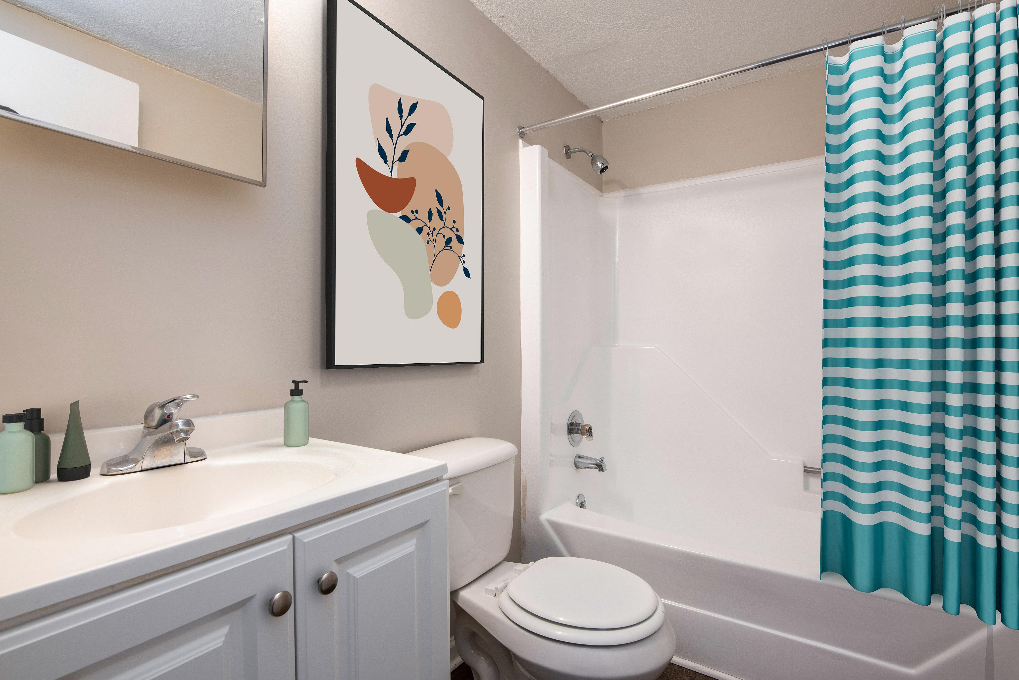 Elegant bathroom featuring modern vanity with stylish artwork and vibrant striped shower curtain, creating a fresh and inviting space.