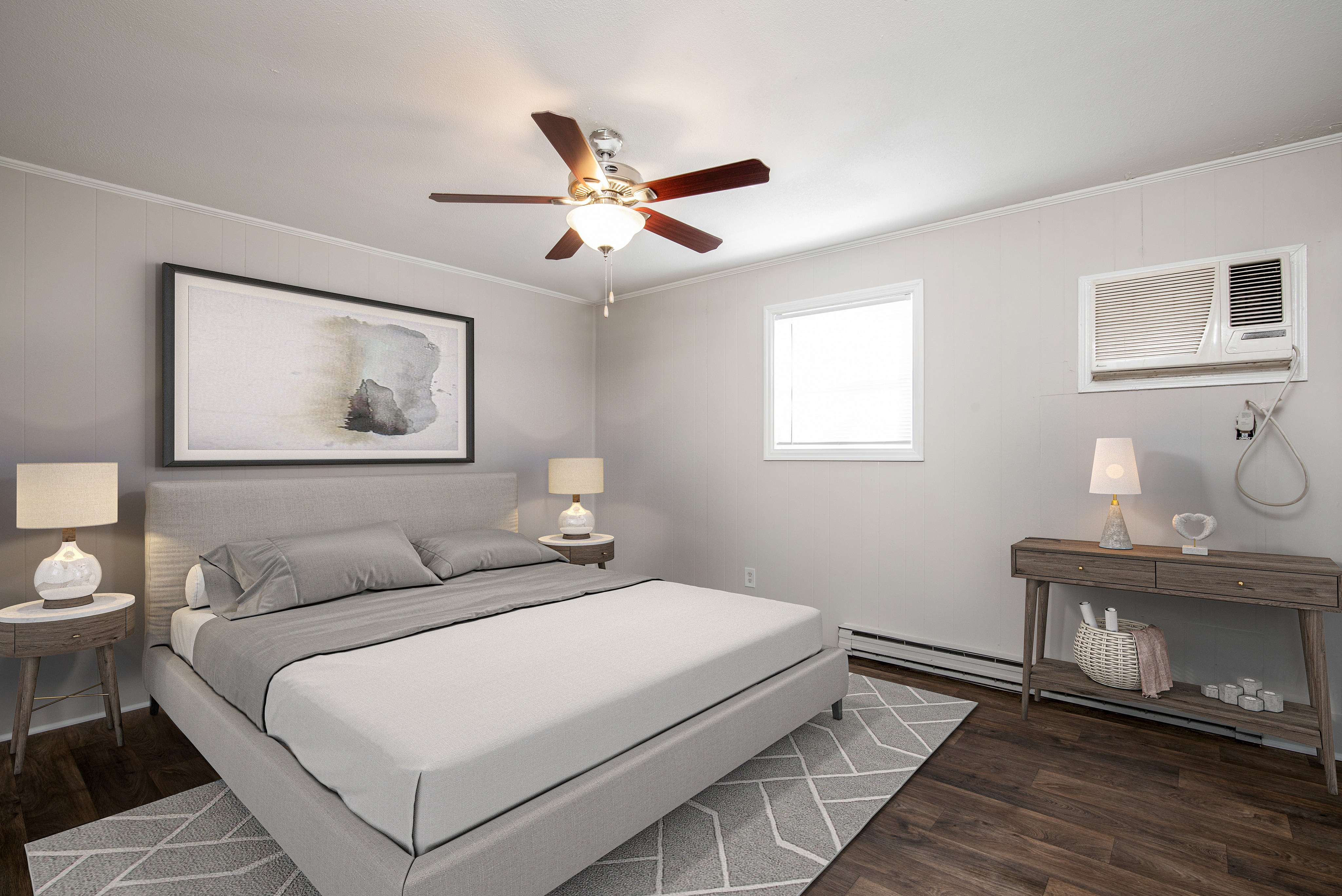 Inviting bedroom with modern decor, featuring a chic grey bed, elegant side tables with lamps, and a stylish ceiling fan.