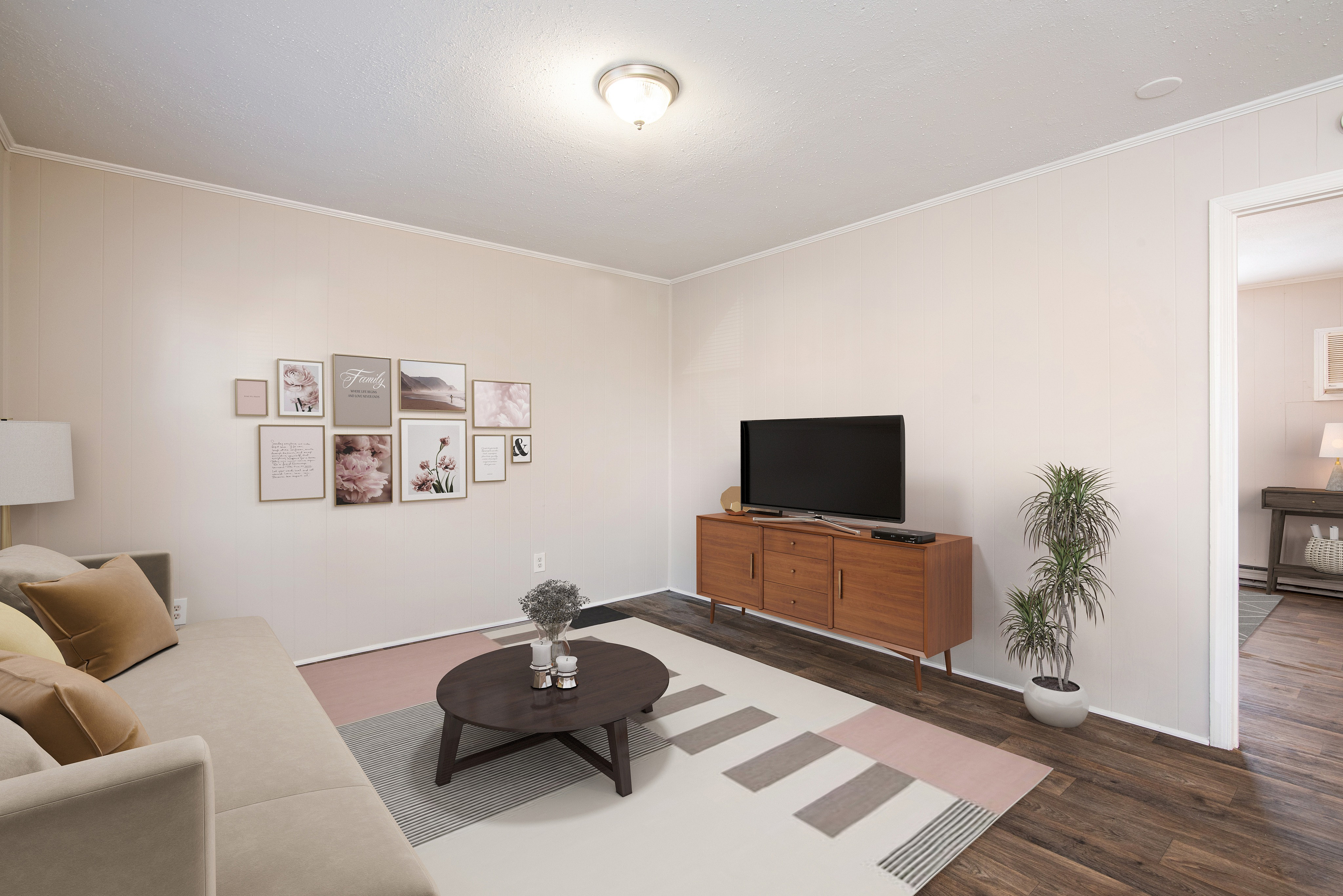 Inviting living room with cozy sofa, elegant wall art, modern TV console, and stylish coffee table, perfect for relaxation.
