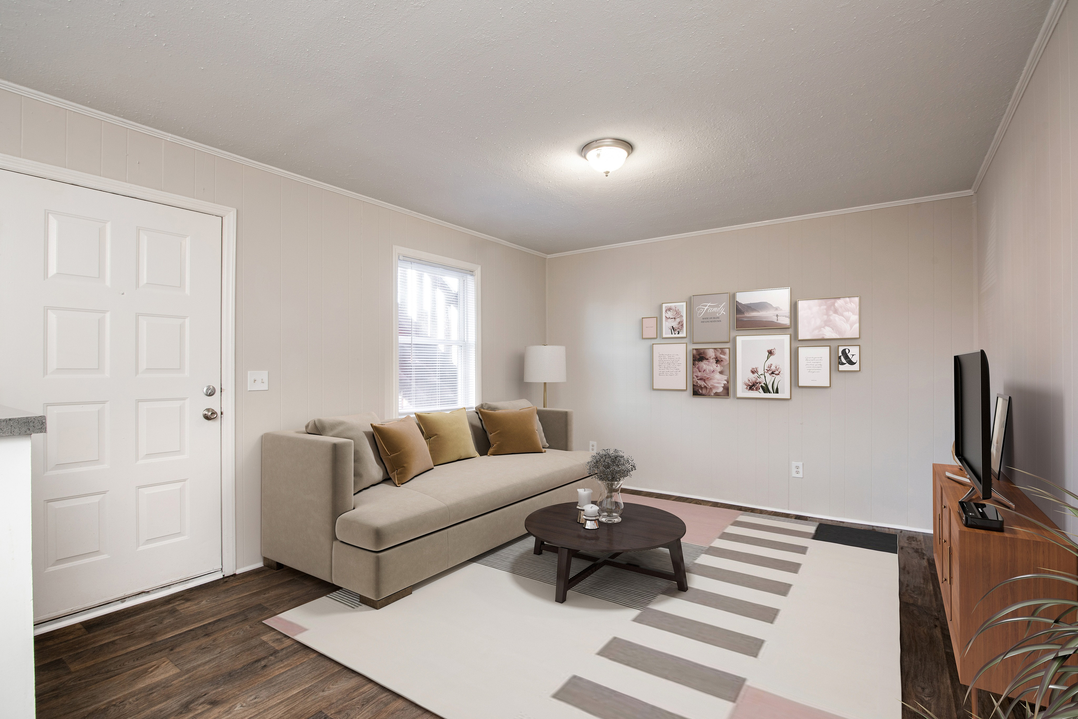 Modern living room with stylish beige sofa, elegant wall art, and cozy atmosphere.