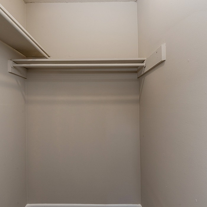 Spacious walk-in closet with ample shelving and hanging space, perfect for organizing your wardrobe.