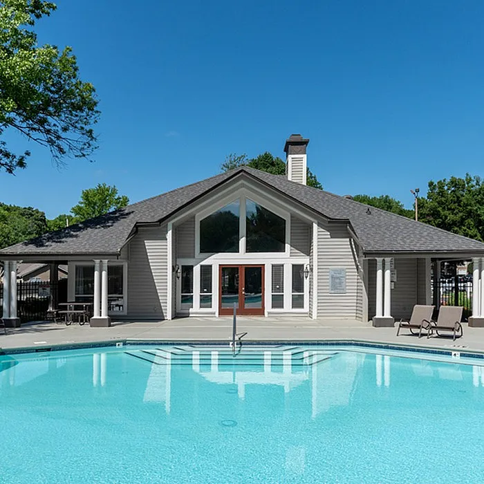 Inviting clubhouse with modern architecture and a sparkling pool, perfect for relaxation and social gatherings.