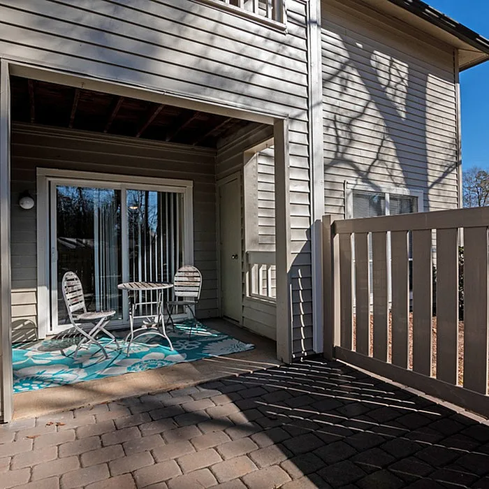 Charming outdoor patio with stylish furniture and private fencing, perfect for relaxation and outdoor entertaining.