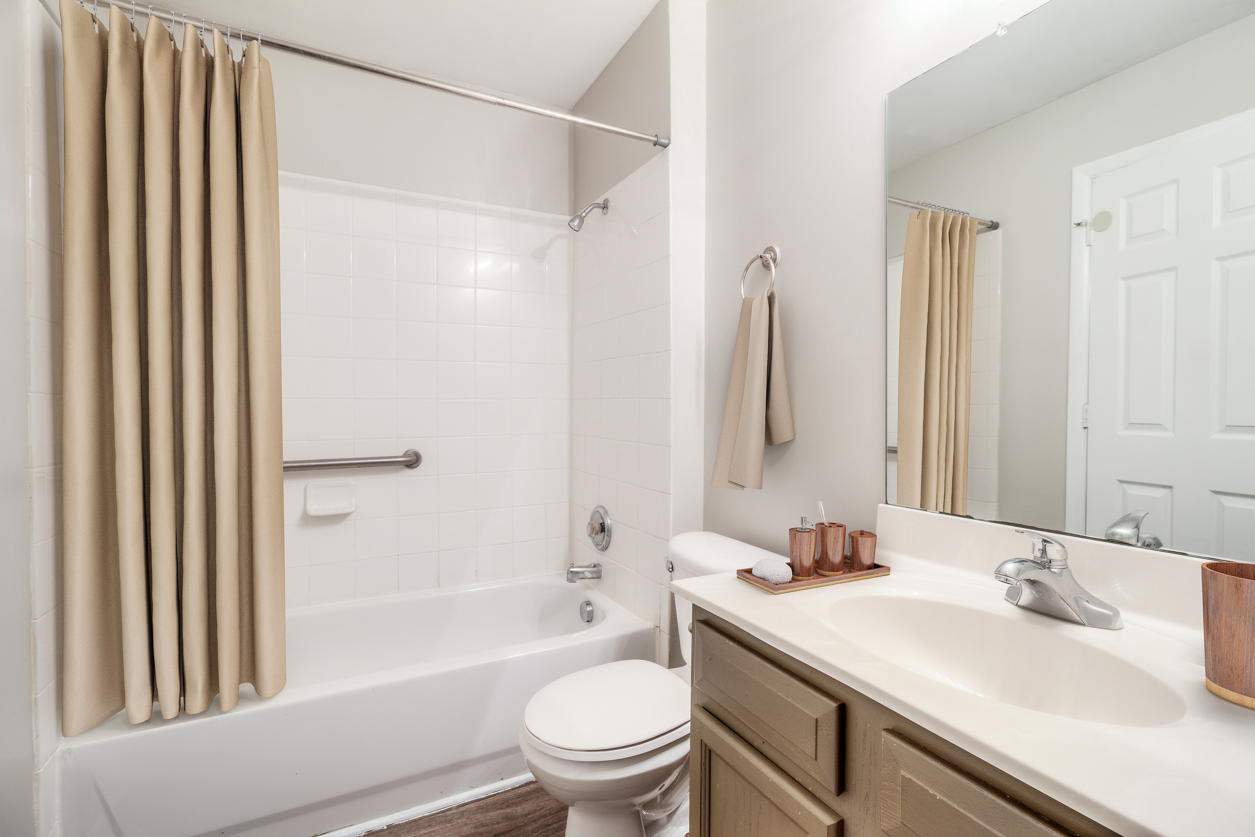 Elegant bathroom featuring a modern sink, sleek faucet, and a pristine shower area with neutral decor accents.