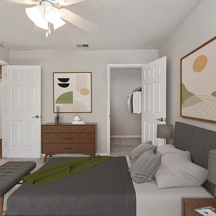 Elegant bedroom with modern decor, featuring cozy grey bedding, a sleek wooden dresser, and stylish wall art. Bright and inviting space with a ceiling fan and ample natural light.
