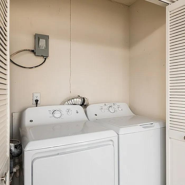 Convenient in-unit laundry with a modern washer and dryer set tucked in a cozy, well-lit alcove.