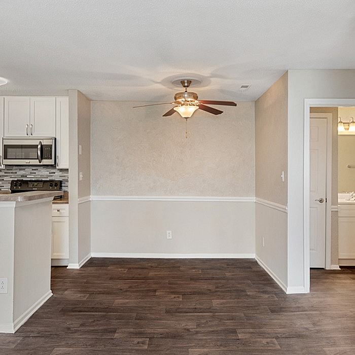 Charming open-concept kitchen and dining area with sleek flooring, modern appliances, and elegant lighting, perfect for cozy gatherings.