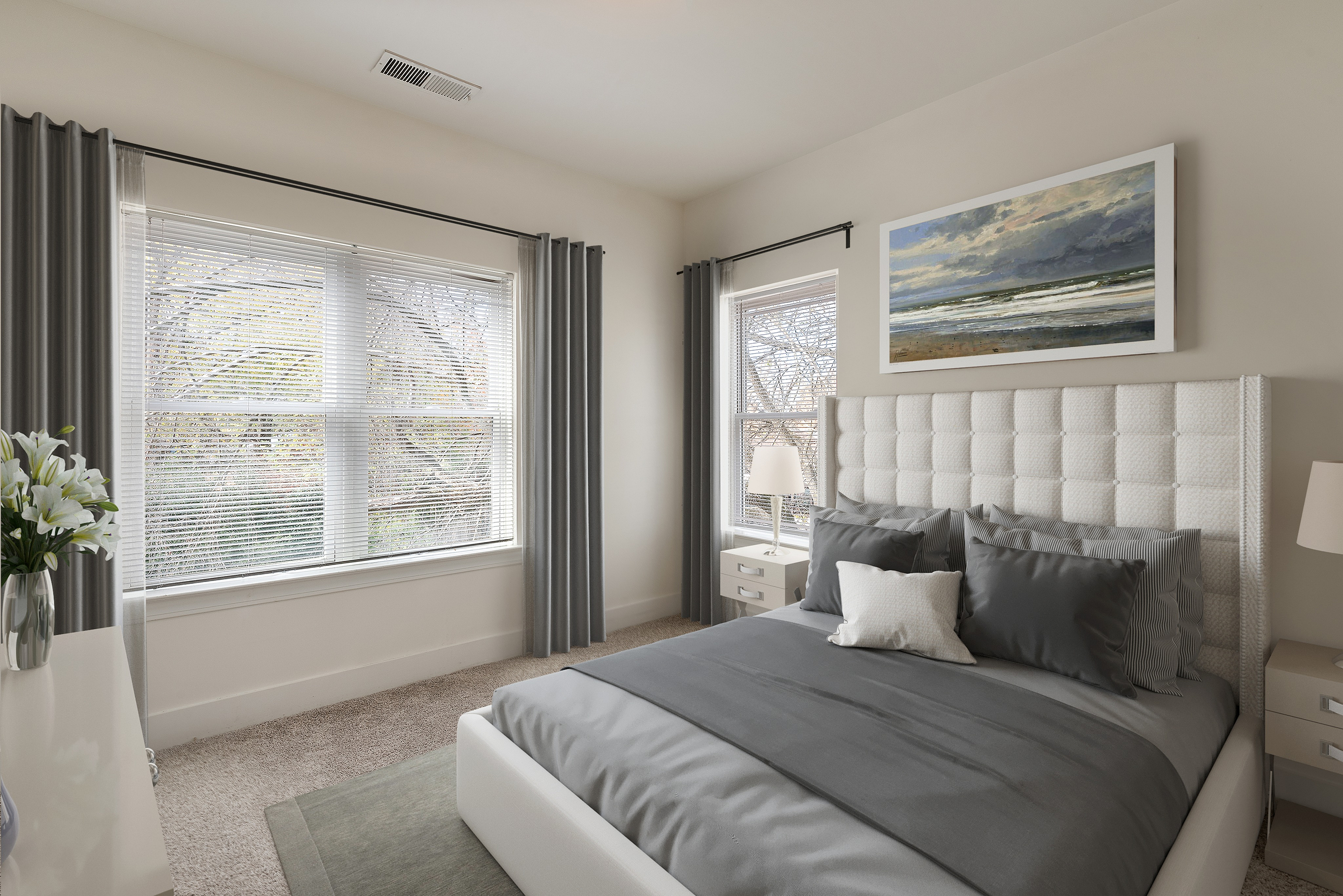 Elegant bedroom with plush bedding, large windows, and calming wall art, creating a serene and inviting atmosphere.