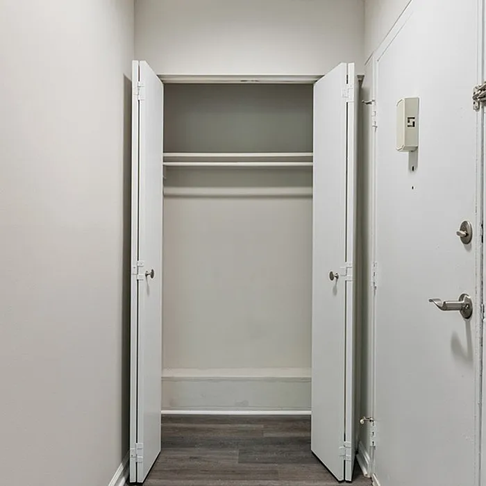 Spacious entryway closet with sleek double doors, perfect for organizing and maximizing storage space.