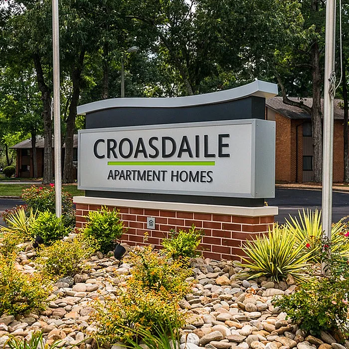 Welcoming front sign of Croasdaile Apartment Homes surrounded by lush greenery and vibrant landscaping, promising a serene living environment.