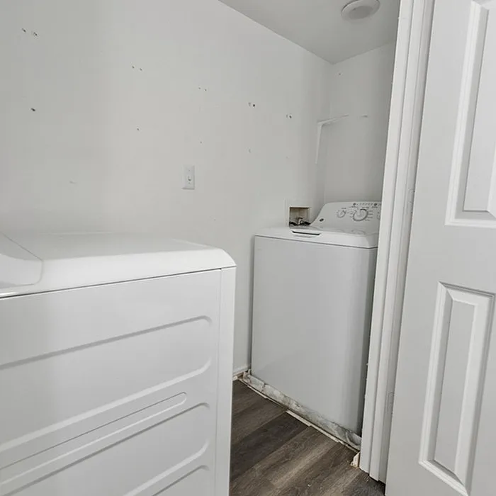 Bright and efficient laundry room featuring modern washer and dryer with sleek design and ample space.