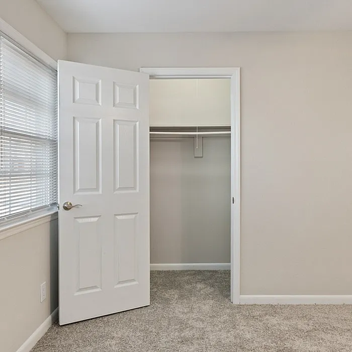 Bright and airy bedroom with plush carpeting and a spacious closet, ready to personalize.