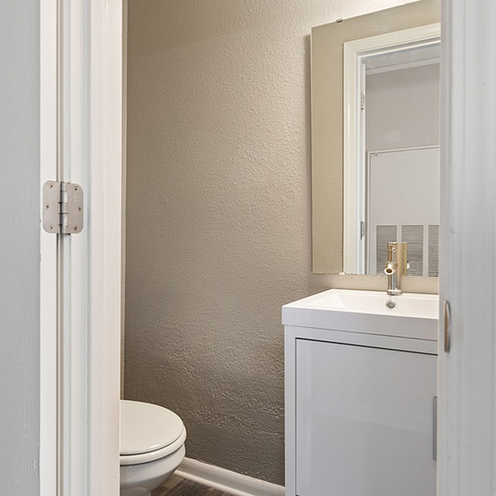 Sleek and modern bathroom with minimalist design and bright lighting.