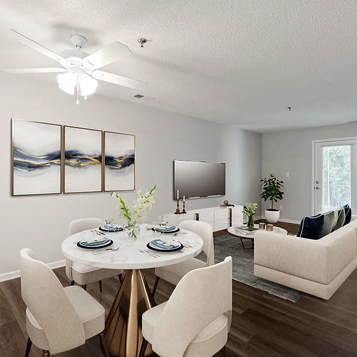 Modern open-concept living and dining area with elegant decor, featuring a stylish round dining table set, cozy seating, and vibrant artwork.