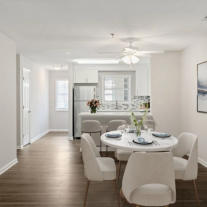 Inviting open-concept dining area with elegant table setting, adjacent to a modern kitchen featuring sleek appliances and stylish decor.