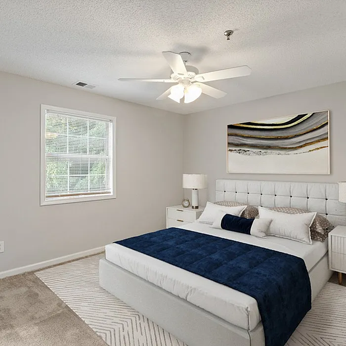 Inviting bedroom with plush bed, modern artwork, and natural light, perfect for relaxation and rest.