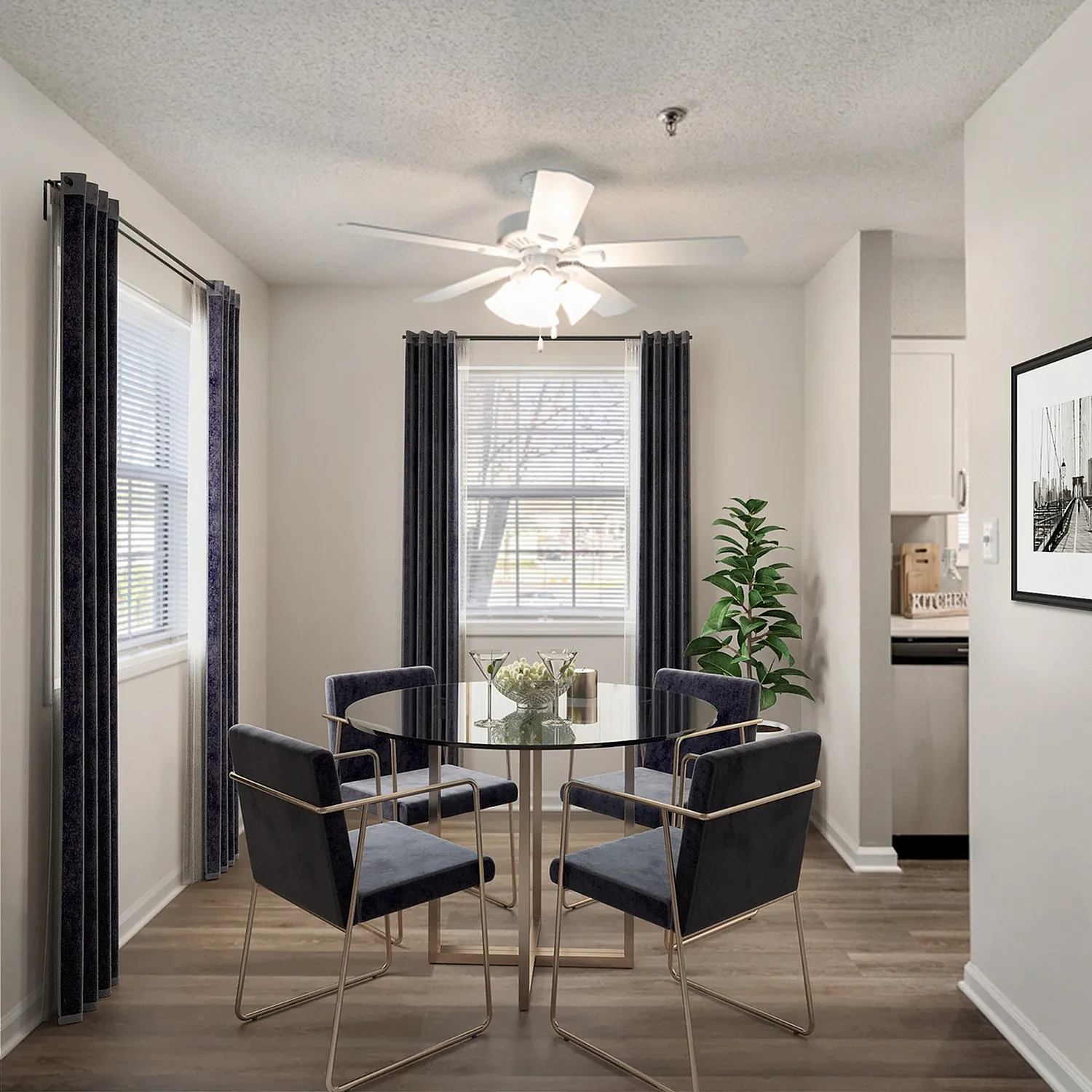 Bright dining area with elegant glass table, modern chairs, and natural light streaming through large windows.