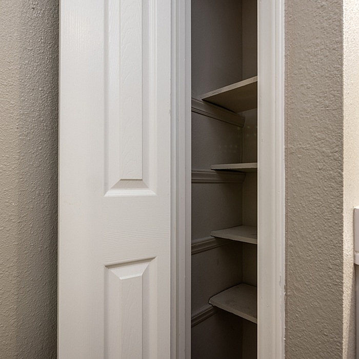 Chic interior closet with ample shelving, perfect for organized storage solutions in a modern home.