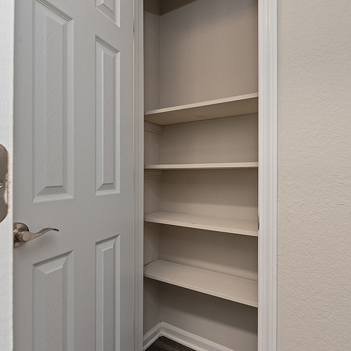 Neatly designed closet with open shelving for optimal storage in a modern apartment.