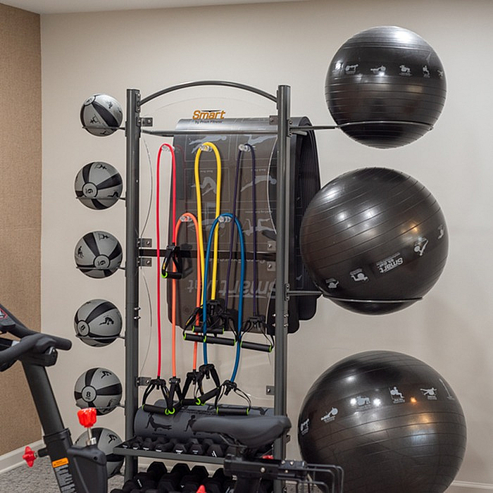 Modern fitness corner featuring a variety of exercise equipment including resistance bands, medicine balls, and stability balls for a versatile workout experience.