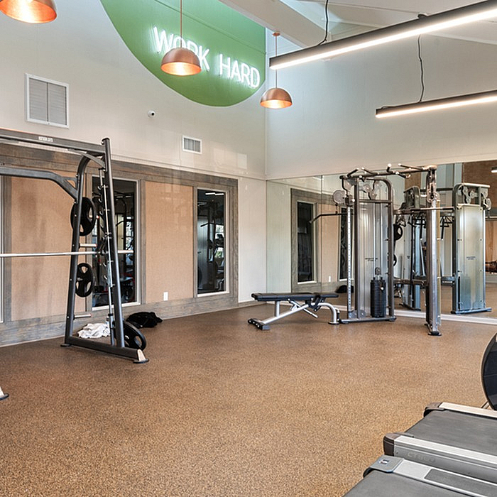 Modern fitness center with state-of-the-art equipment and motivational 'Work Hard' sign, optimal for achieving workout goals.