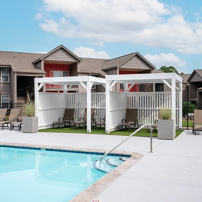 Luxurious outdoor pool area with stylish seating and elegant cabanas, perfect for relaxation and unwinding under the open sky.