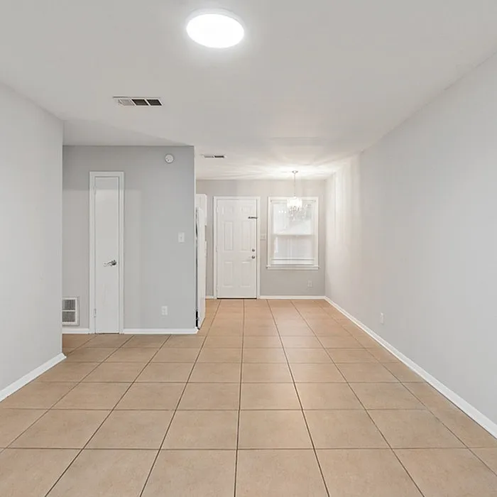 Bright and airy apartment featuring spacious tile flooring, contemporary lighting, and a welcoming entryway.