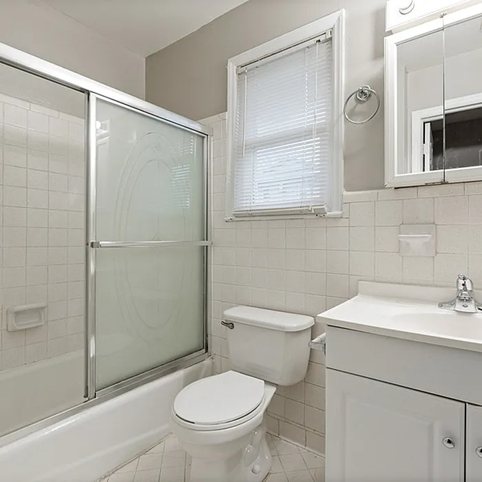 Bright and modern bathroom featuring a sleek shower enclosure, elegant vanity, and stylish tilework.