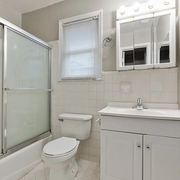 Bright and inviting bathroom featuring a modern vanity, glass-enclosed shower, and elegant lighting for a serene atmosphere.