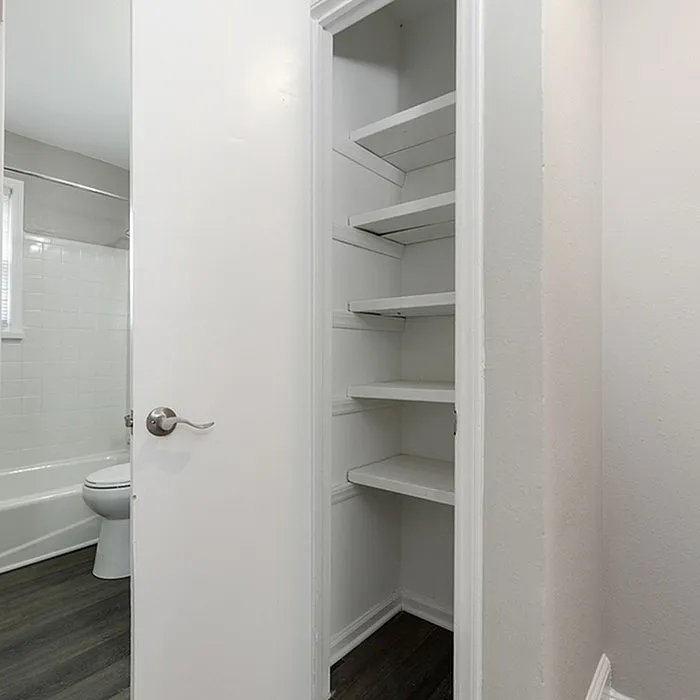 Chic bathroom with modern white shelving, offering ample storage space and contemporary design.
