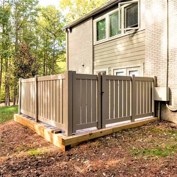 Charming fenced patio area enhancing the outdoor appeal of a cozy apartment, surrounded by lush greenery.