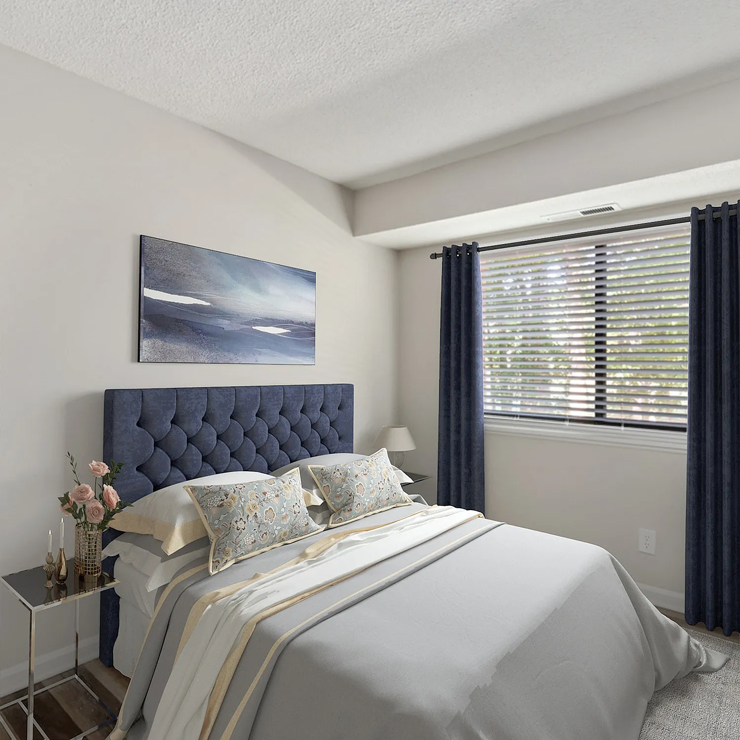 Inviting bedroom with a plush, tufted blue headboard, elegant decor, and abundant natural light through large windows.