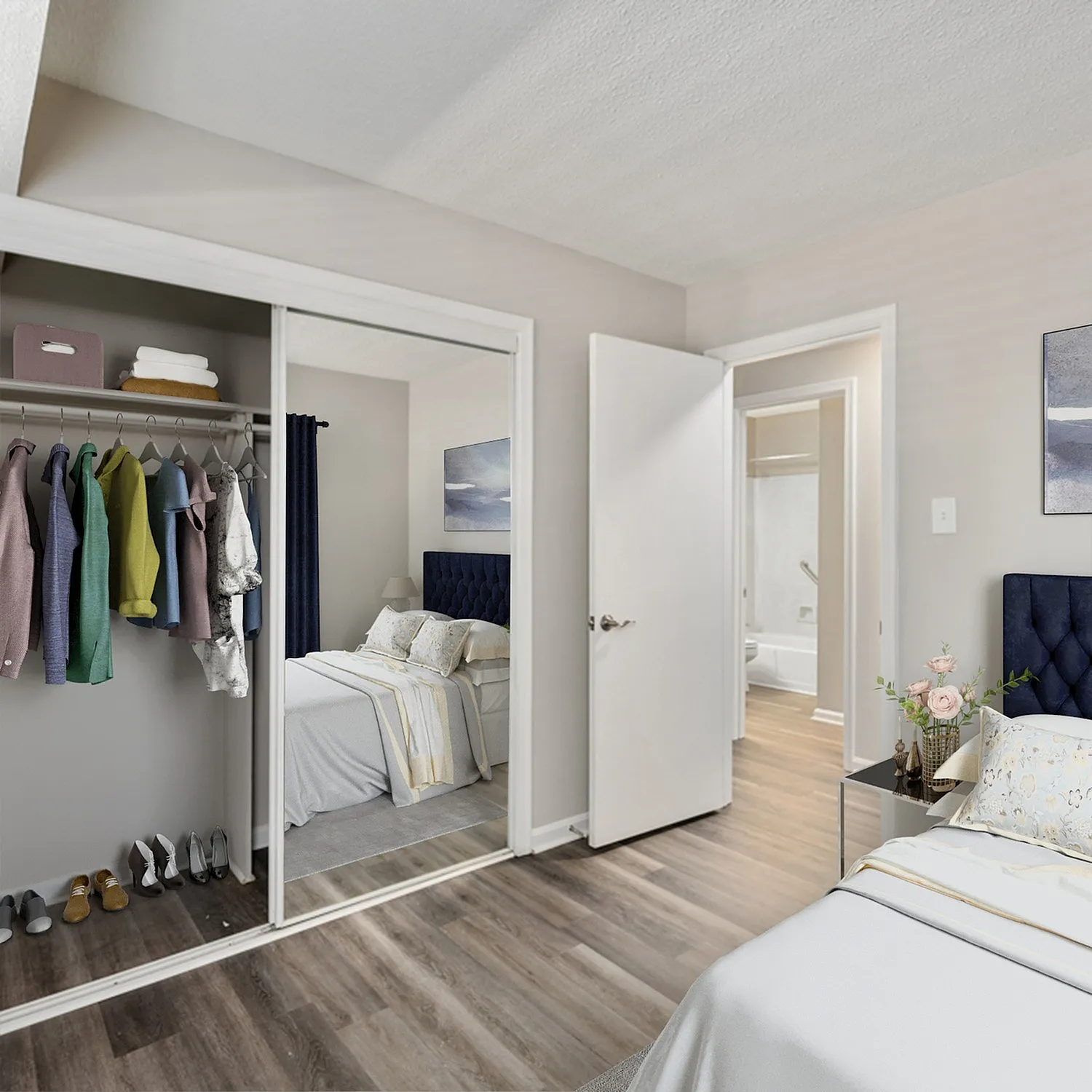 Elegant bedroom with sleek mirrored closet doors, stylish decor, and inviting ambiance, perfect for relaxation and comfort.