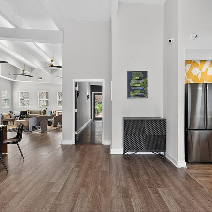 Modern interiors featuring an open-concept living space with elegant wood flooring, contemporary furniture, and sleek stainless steel appliances.
