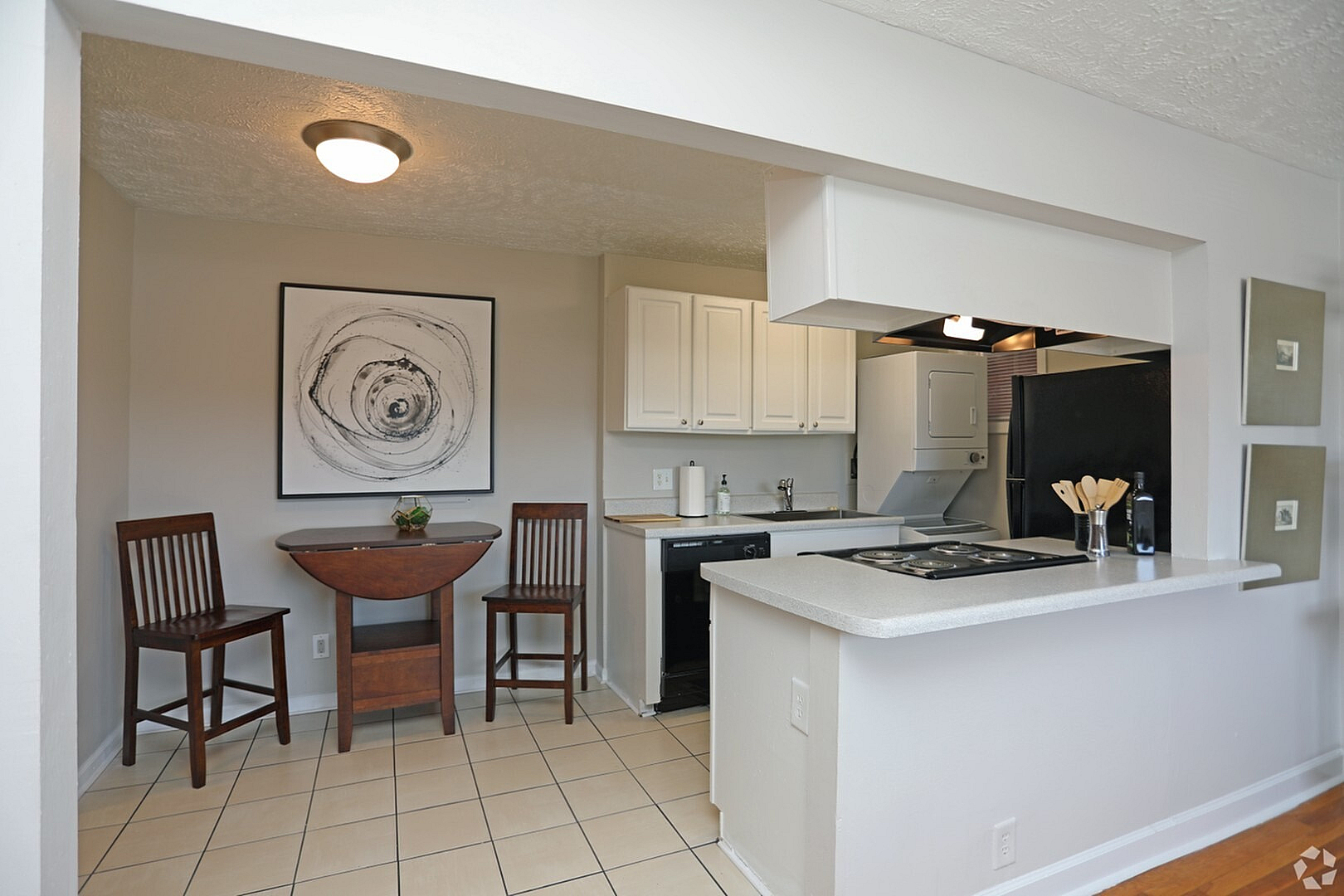 Charming kitchen nook with modern decor, featuring a cozy dining area and sleek countertops, perfect for intimate gatherings.