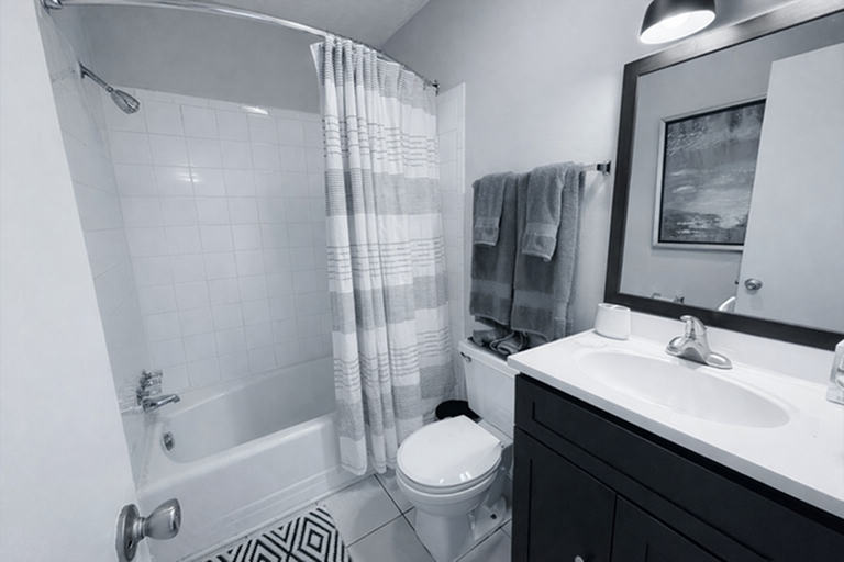 Modern bathroom with elegant lighting, sleek vanity, and contemporary shower design.