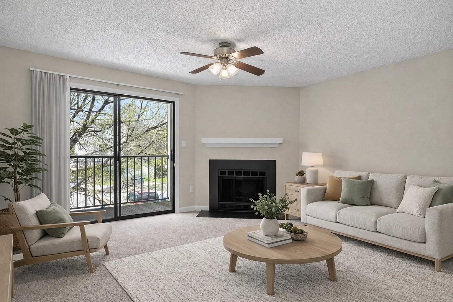 Bright and inviting living room with a cozy fireplace, comfy seating, and large sliding doors leading to a scenic view.