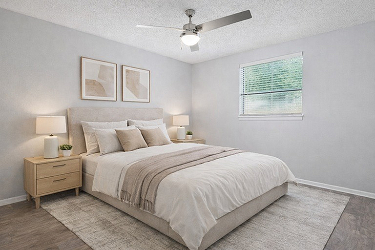 Elegant bedroom with soft neutral tones, stylish decor, and a cozy atmosphere featuring a plush bed, modern artwork, and ample natural light.