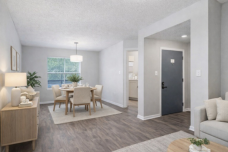 Inviting dining area with elegant decor, large window, and stylish wood flooring, perfect for entertaining.