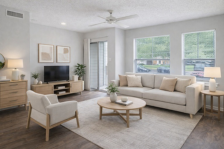 Bright and inviting living room with modern furnishings, large windows, and a serene neutral color palette.