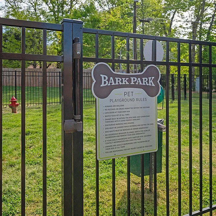 Inviting Bark Park entrance in a pet-friendly community, featuring lush green spaces and thoughtful playground rules for a great canine experience.