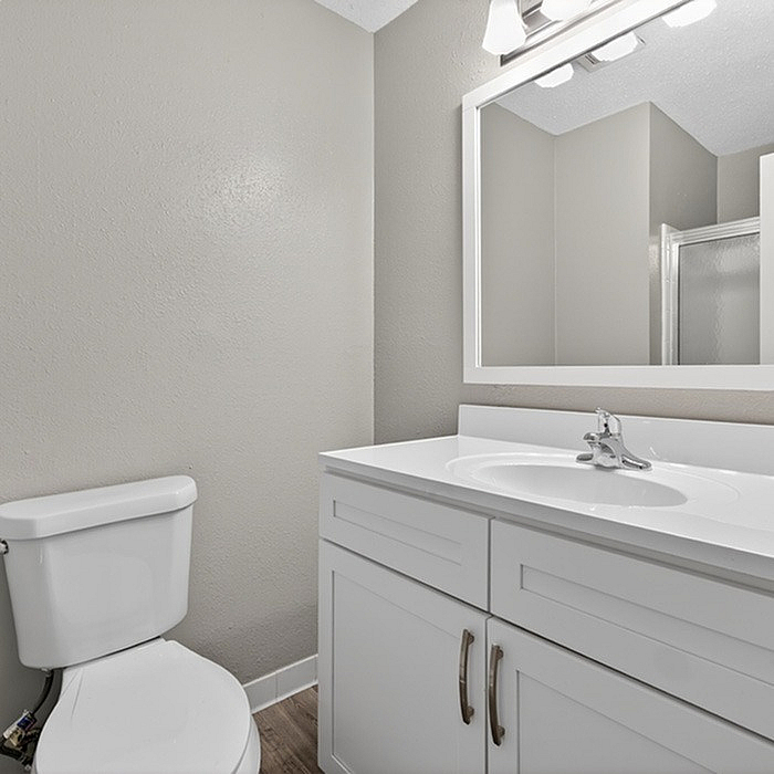 Elegant bathroom with modern fixtures, a sleek vanity, and ample natural light creating a serene atmosphere.