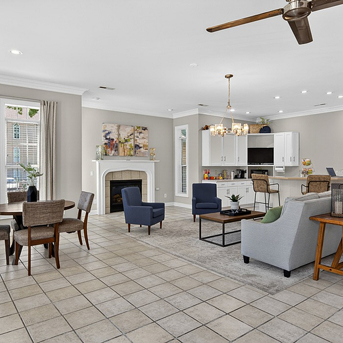 Elegant open-concept living area with chic furnishings, spacious layout, and a cozy fireplace. Perfect for entertaining and relaxation.