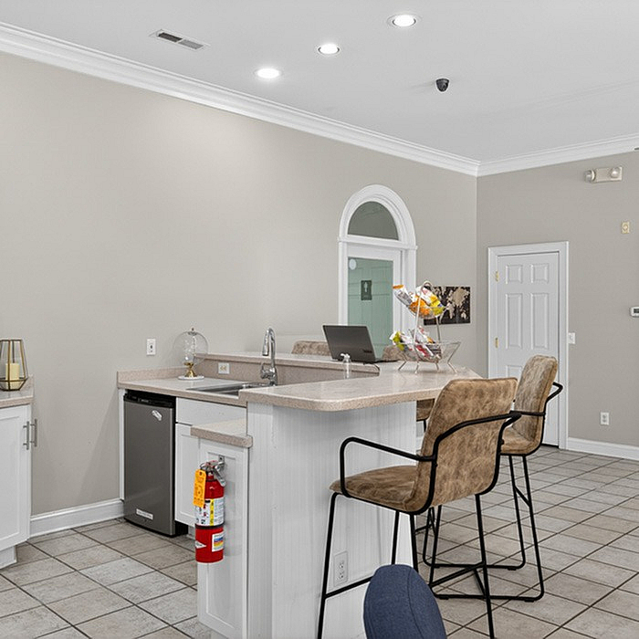 Elegant apartment kitchen featuring a stylish breakfast bar with comfortable seating and ambient lighting.