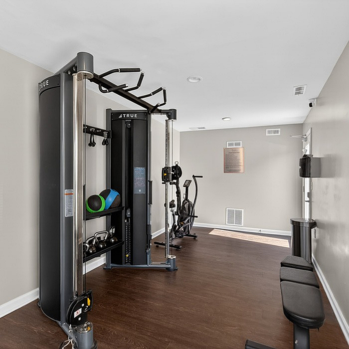 Sleek modern gym with state-of-the-art fitness equipment and open space for exercise.