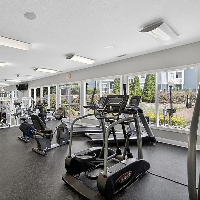 Bright and airy fitness center featuring modern exercise equipment and large windows offering scenic views.