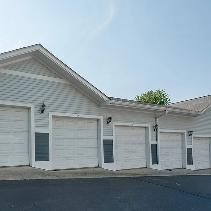 Modern apartment building with well-maintained garages and stylish exterior design.