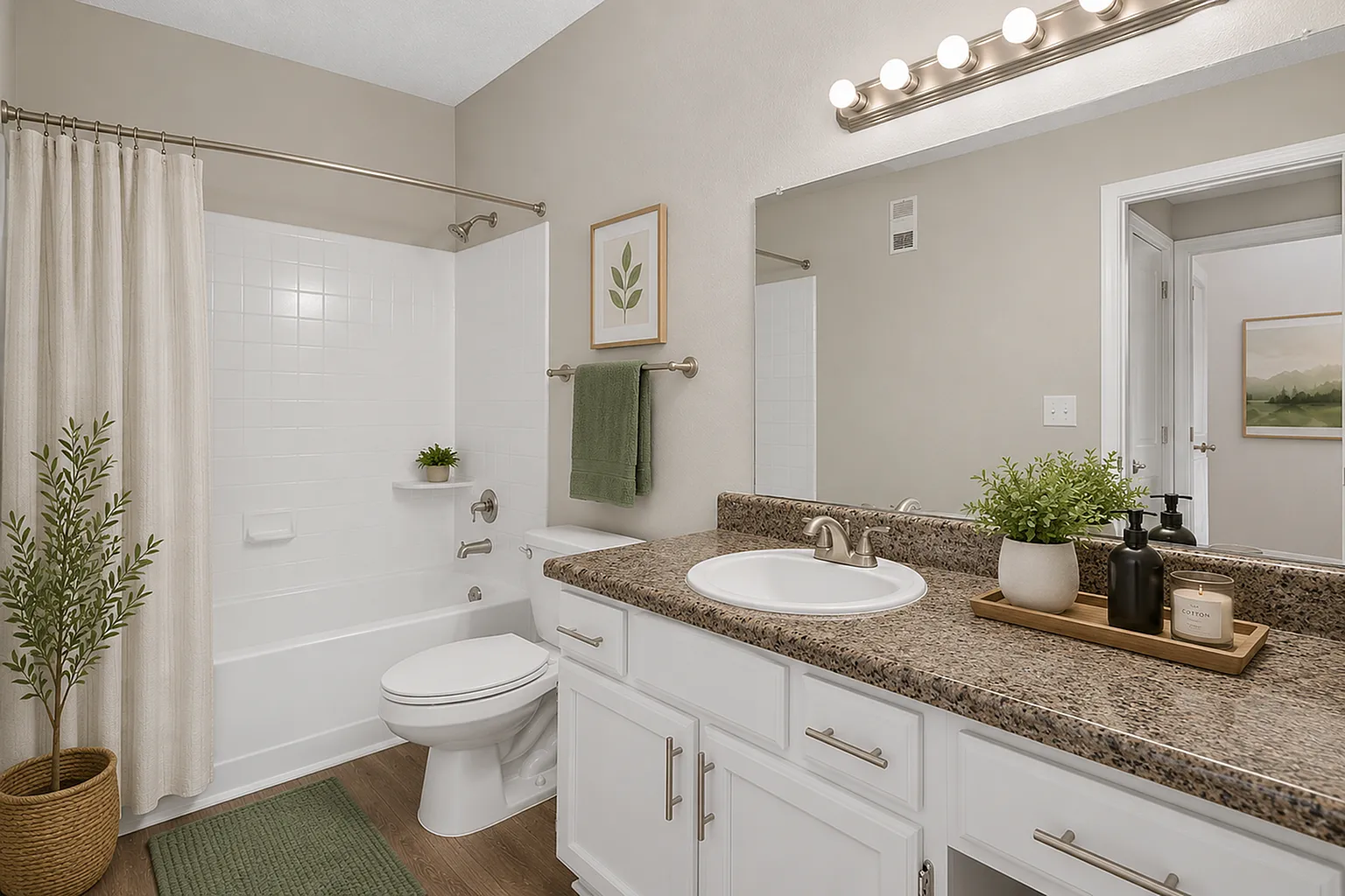 Elegant bathroom with a granite countertop, modern lighting, and stylish decor, featuring a pristine bathtub and lush greenery accents.